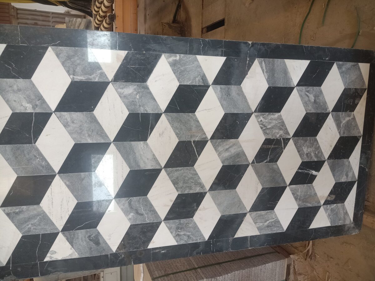 Marble floor panel in a three-dimensional cube pattern, in black, white and grey stone