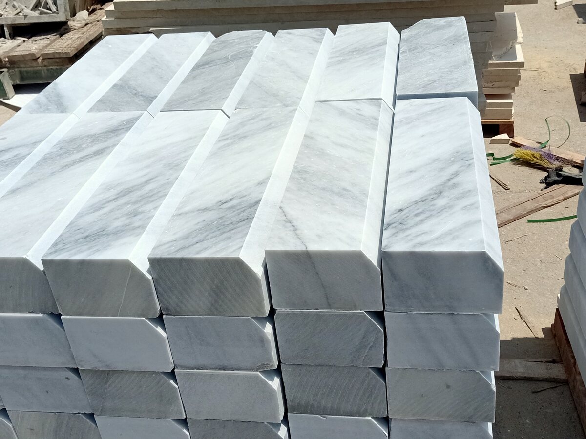 Stacks of white marble stair treads with bullnose edges
