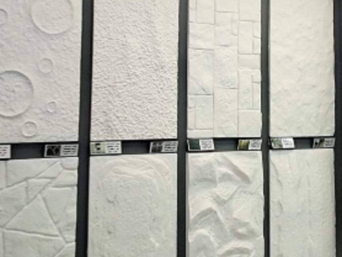 Display of white three-dimensional carved stone wall panels